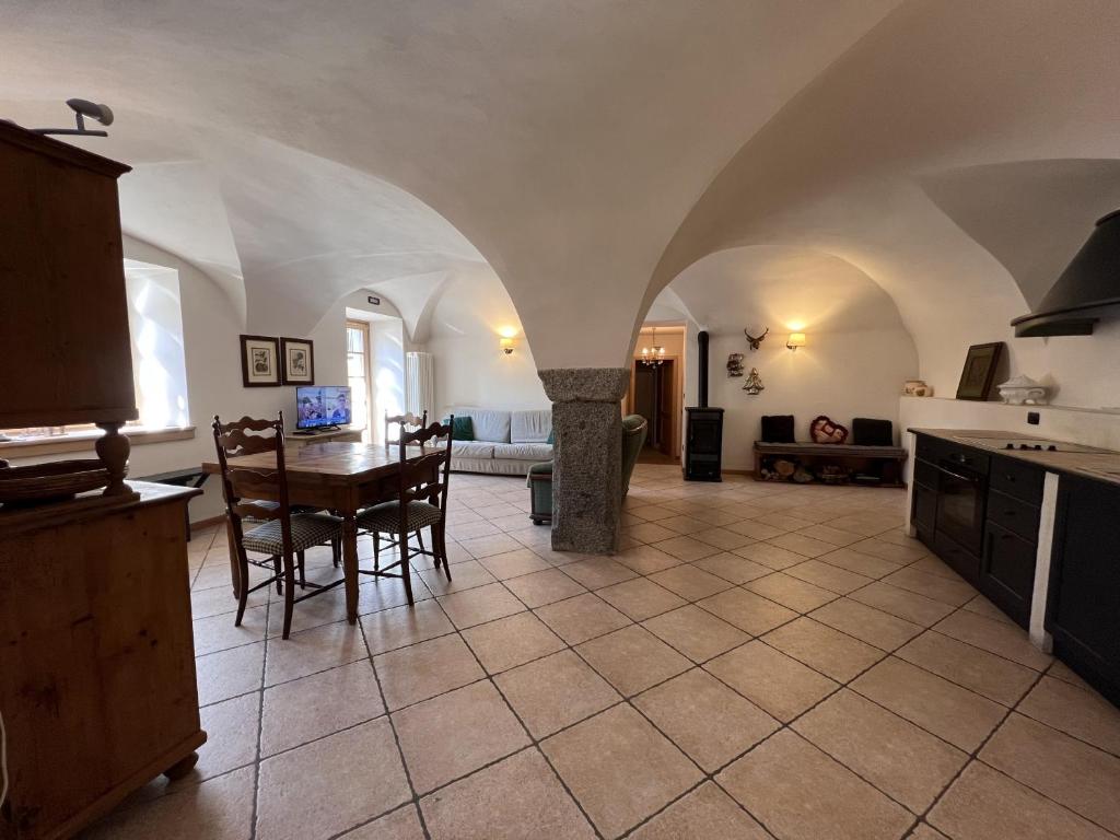 a kitchen and living room with a table and chairs at Trilocale Giustino Vadaione in Giustino
