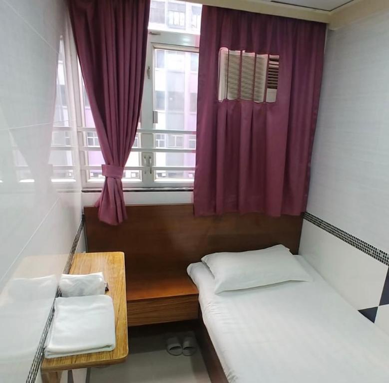 Postel nebo postele na pokoji v ubytování 香港百乐宾馆 Best Guesthouse
