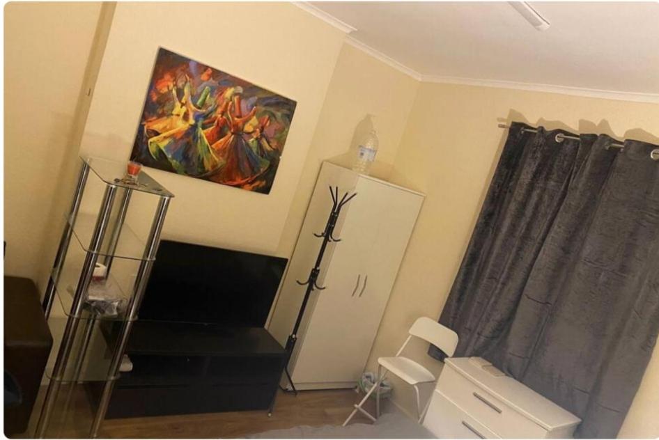a living room with a painting on the wall at Double room #1 in Hounslow