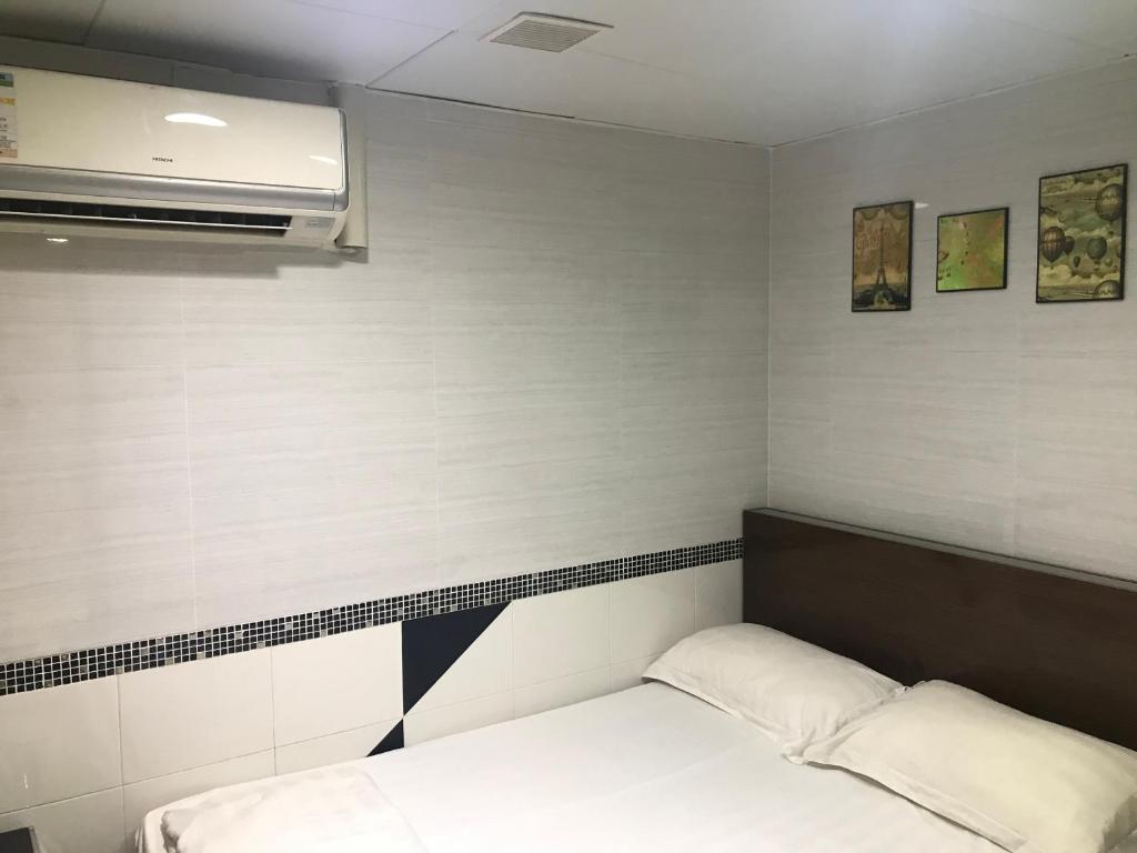 Postel nebo postele na pokoji v ubytování 香港百乐宾馆 Best Guesthouse