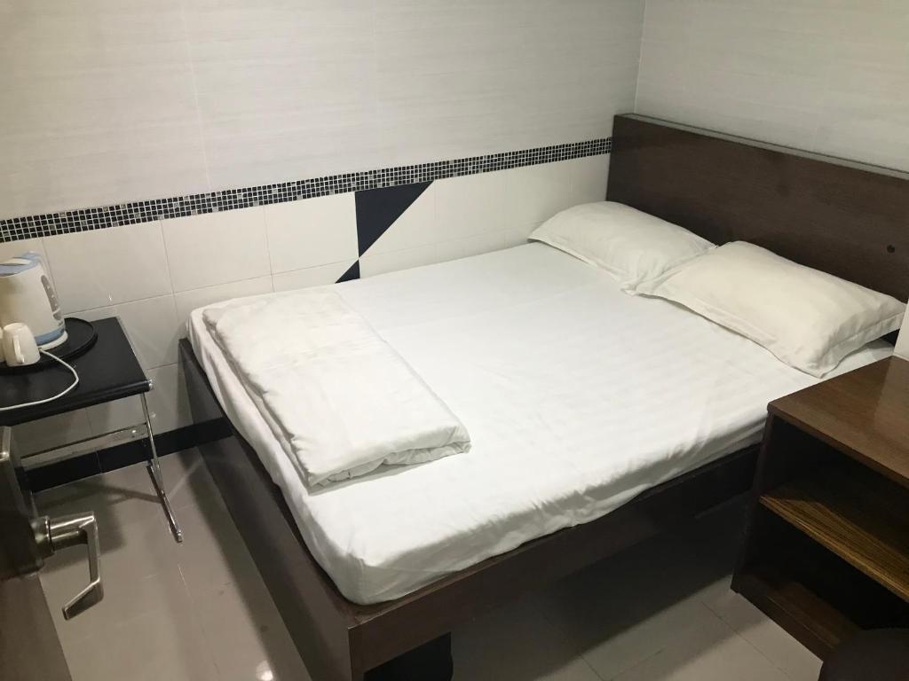 Postel nebo postele na pokoji v ubytování 香港百乐宾馆 Best Guesthouse