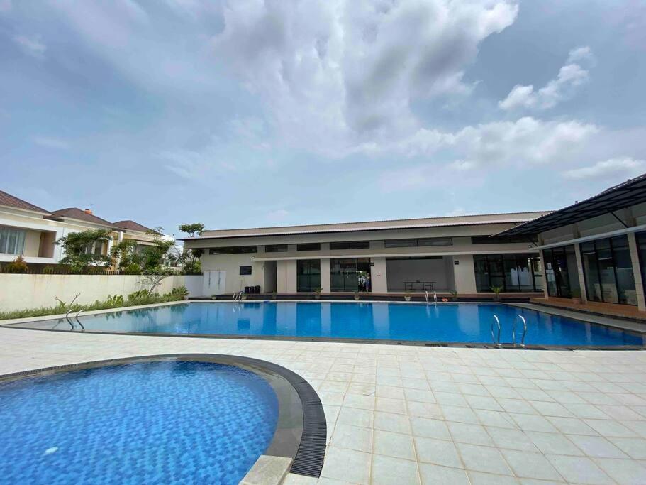 a large swimming pool in front of a building at Monde Residence K No 02 Batam Centre in Sengkuang