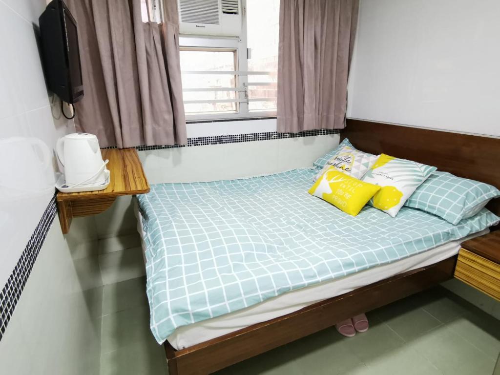 Postel nebo postele na pokoji v ubytování 香港百乐宾馆 Best Guesthouse
