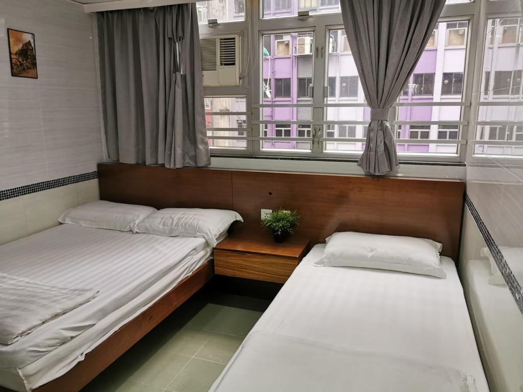 Postel nebo postele na pokoji v ubytování 香港百乐宾馆 Best Guesthouse