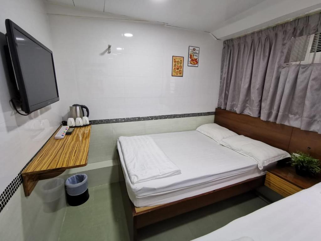 Postel nebo postele na pokoji v ubytování 香港百乐宾馆 Best Guesthouse