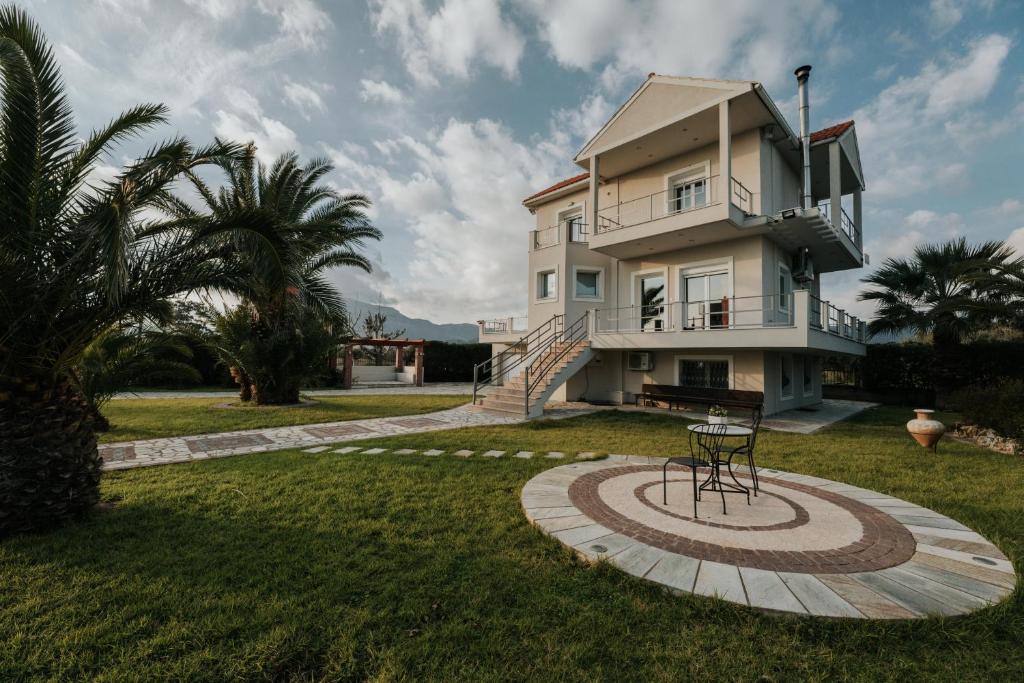 a house with a spiralling yard in front of it at Ponte Suites in Antirrio