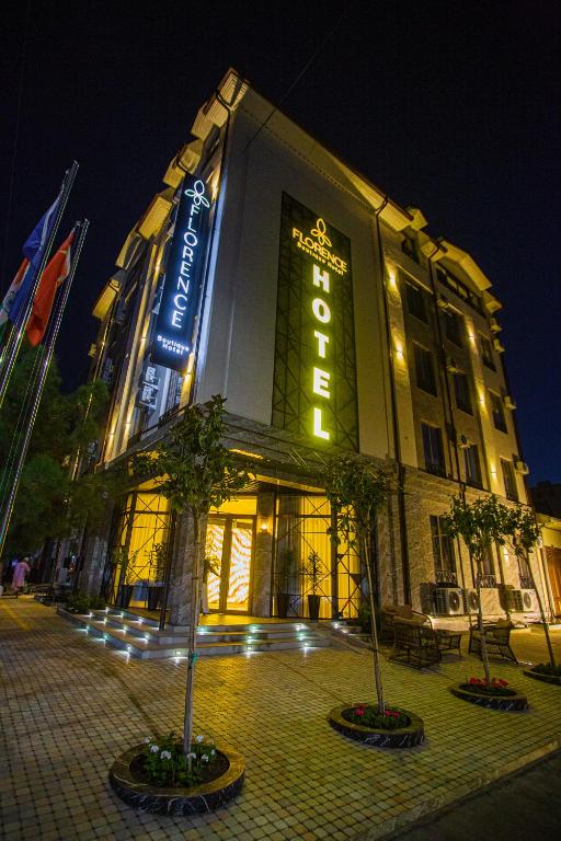 a large building with a sign on it at night at Florence Boutique Hotel by Hotel Pro group in Yakkasaray