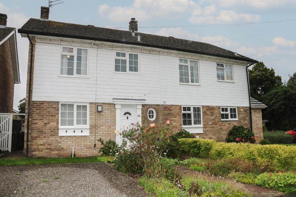 a white and brick house with a white door at 83 Oaklands Road in Havant