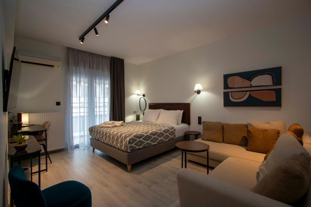 a hotel room with a bed and a couch at #ATS - Embassy Elegant Suite in Thessaloniki