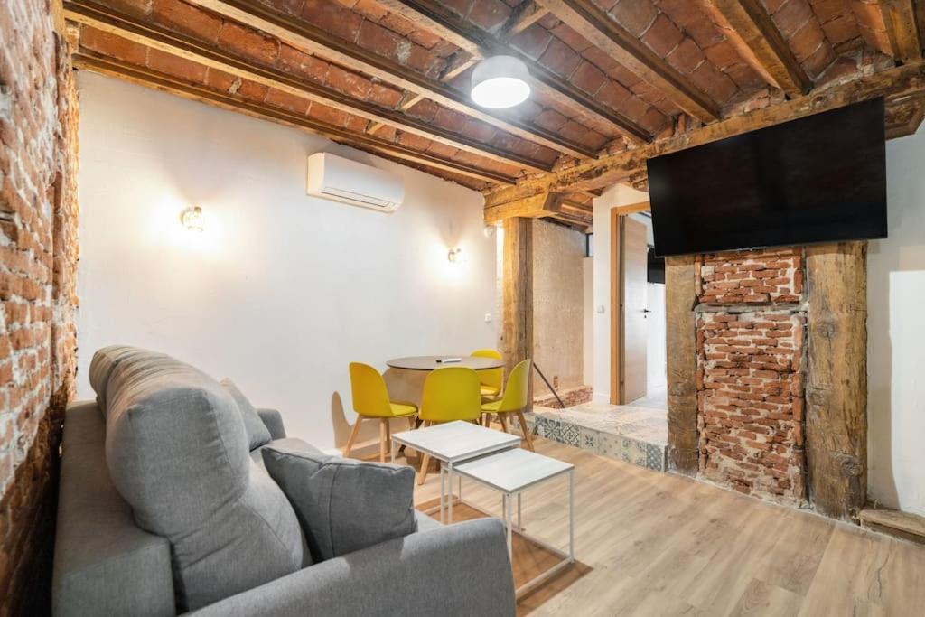 ein Wohnzimmer mit einem Sofa und einem Tisch in der Unterkunft Nice flat in Lavapiés at street level S23B in Madrid