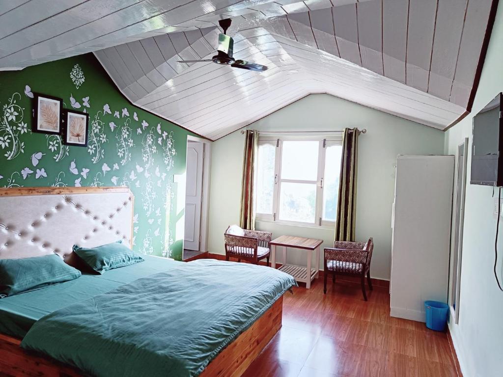 a bedroom with a bed and a green wall at Hill Side Inn in Shimla