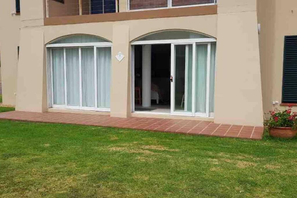 a house with sliding glass doors in a yard at Unobstructed sea view gem (1 Spindrift) in St Francis Bay