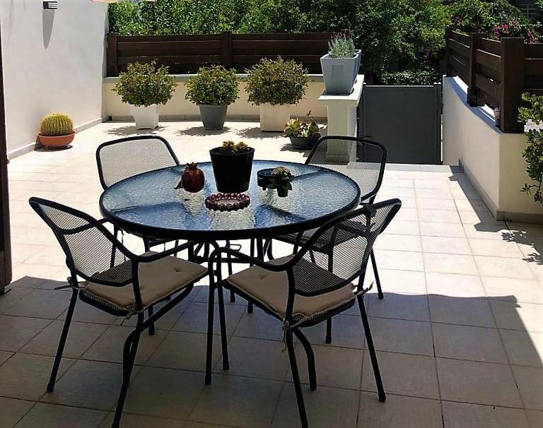 a table and chairs sitting on a patio at John's house in Rhodes Town