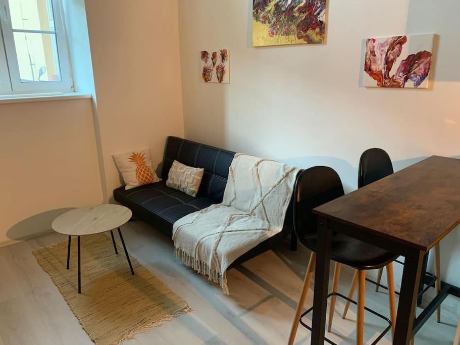a living room with a couch and a table at Apartmán Charmant in Kroměříž