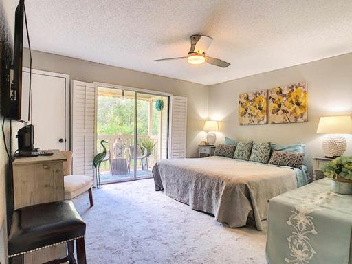 a bedroom with a bed and a couch and a window at Stunning Tree Tops Apt - Disney! in Kissimmee