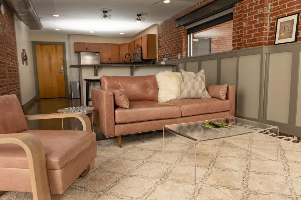 a living room with a couch and a table at Luxury 2 Br Apartment With Modern Accents Downtown in Roanoke