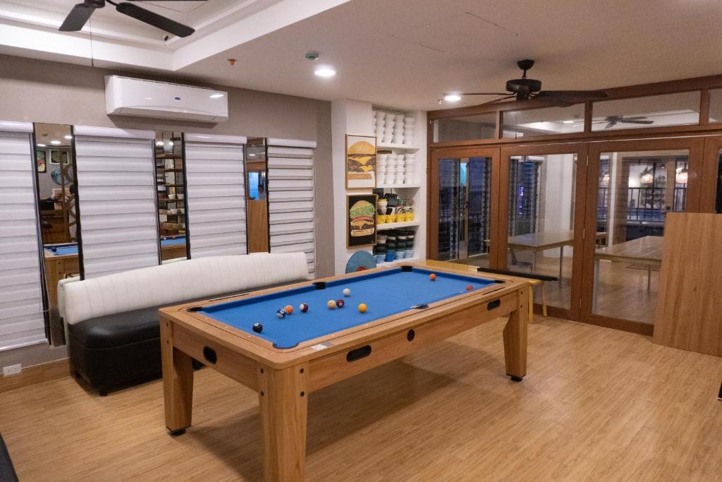 a living room with a pool table and a couch at Urban Glamp Resort in Oton