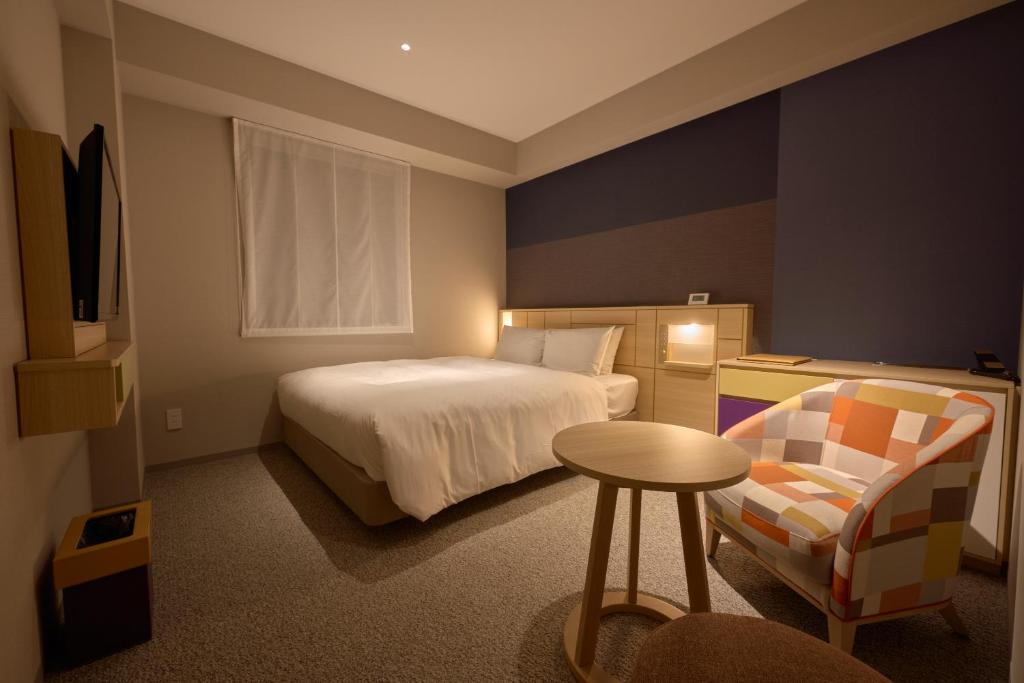 Postel nebo postele na pokoji v ubytování Hotel Intergate Kanazawa