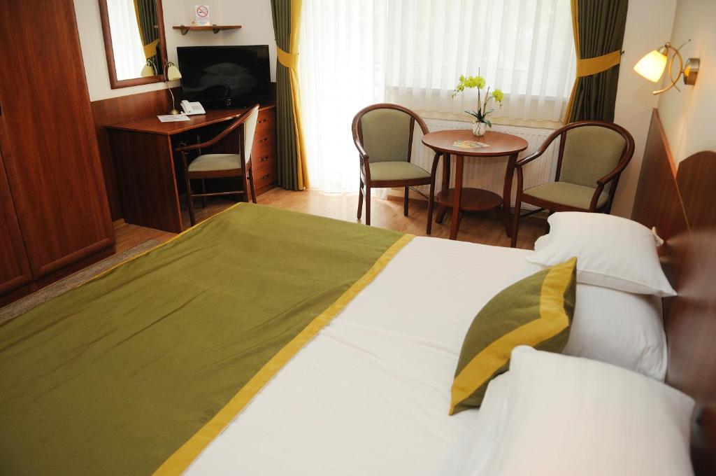 Postel nebo postele na pokoji v ubytování Apartman Bella Hotel