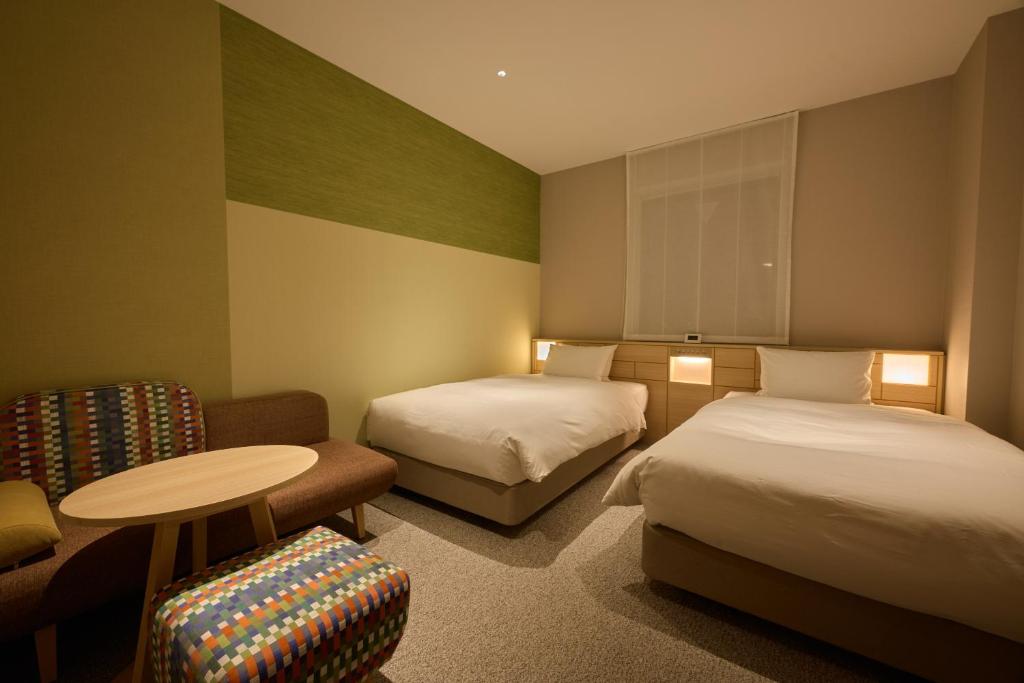 Postel nebo postele na pokoji v ubytování Hotel Intergate Kanazawa