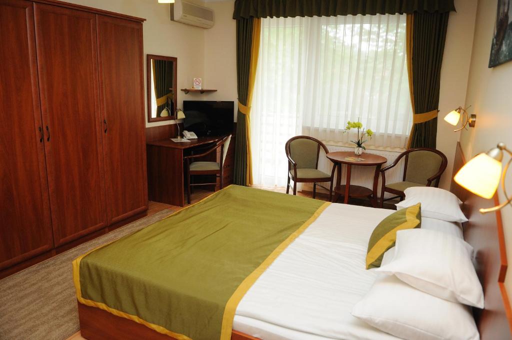 Postel nebo postele na pokoji v ubytování Apartman Bella Hotel