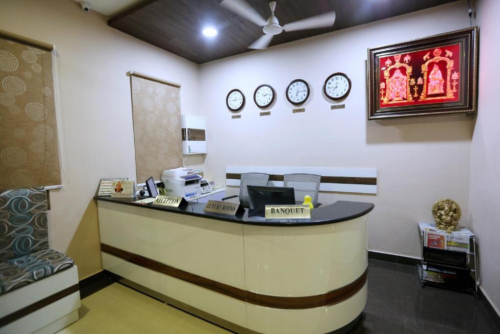 a waiting room with a counter with clocks on the wall at Hotel Sitara Grand Ramchandrapuram in Hyderabad