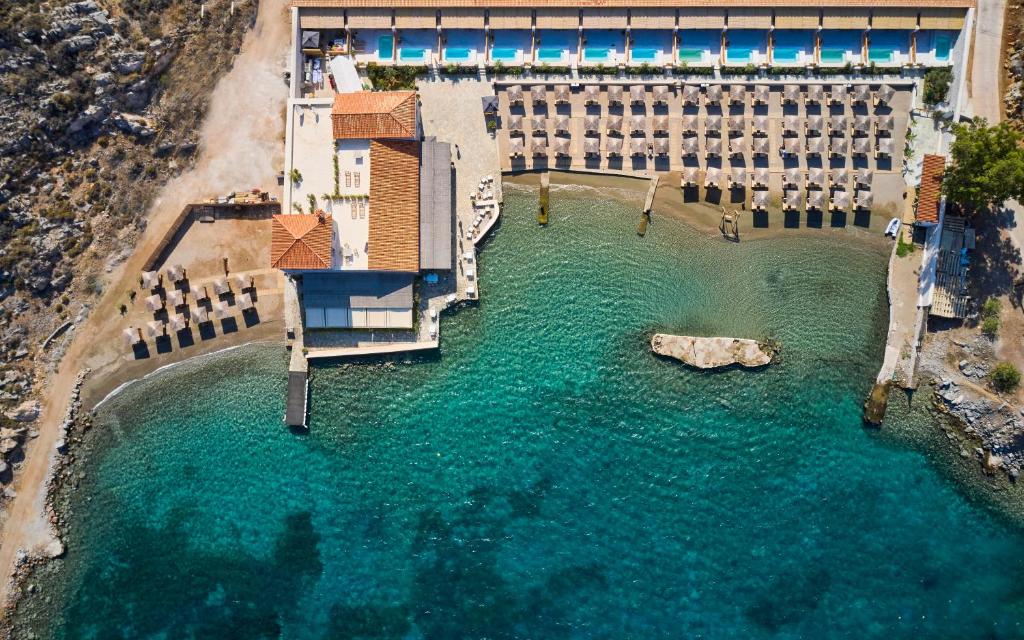 an aerial view of a building in a body of water at Mandraki Beach Resort in Mandraki