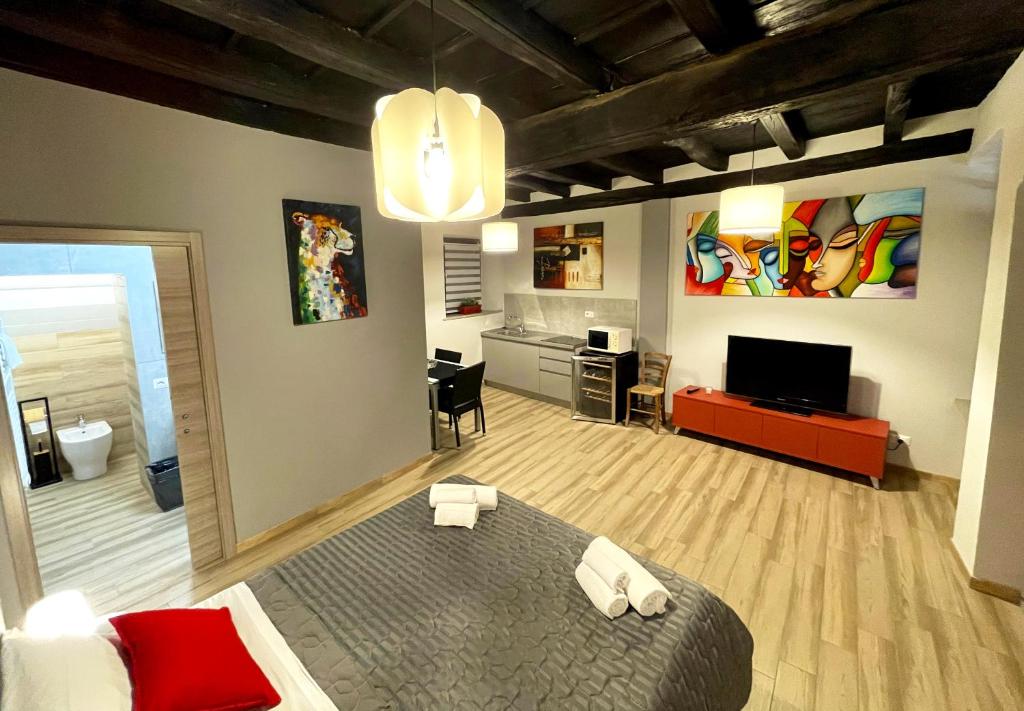 フォッサーノにあるLE TORRI Loft Apartmentのベッドルーム1室(ベッド1台付)、リビングルームが備わります。