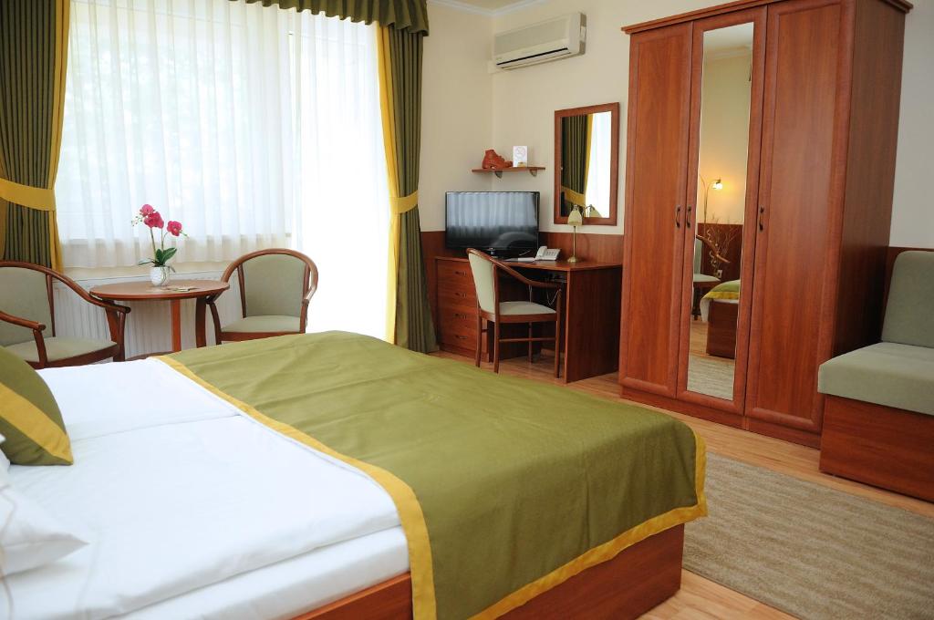 Postel nebo postele na pokoji v ubytování Apartman Bella Hotel