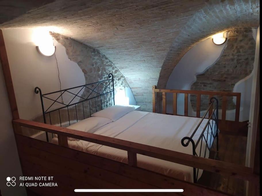 a bedroom with a bed in a stone wall at CasaNella in Lanciano