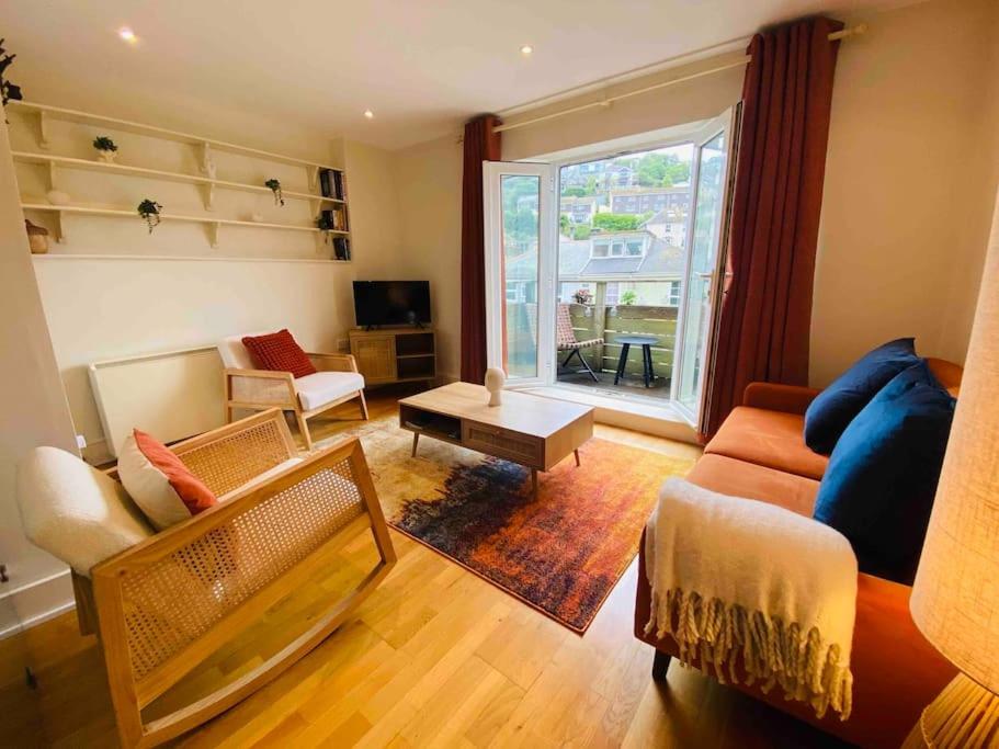 a living room with a couch and a table at The Salt Box in Dartmouth