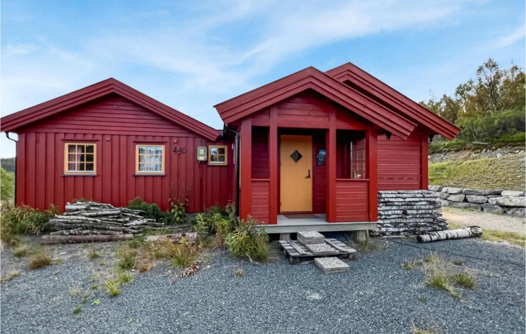 a red house with a yellow door next to another red house at Amazing Home In Reinli With 3 Bedrooms in Reinli