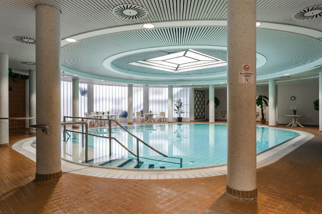 a large swimming pool in a building with a ceiling at Loft in an old factory in Turku