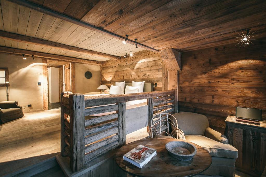 a room with a table in a log cabin at Zannier Hotels Le Chalet in Megève