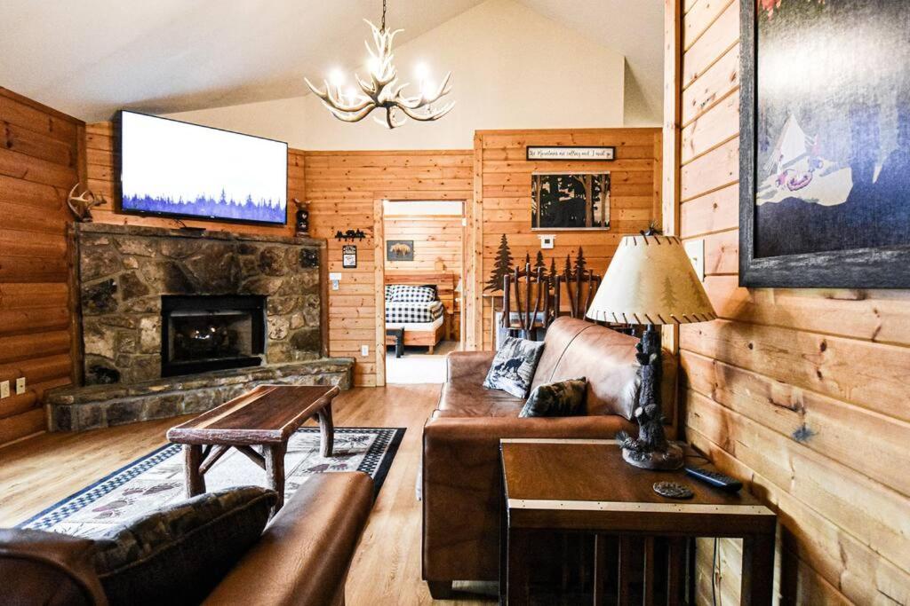 a living room with a couch and a fireplace at Four Private Suites - Hot Tub - Arcade - Fast Wi-Fi - One Minute To Parkway Fun in Pigeon Forge