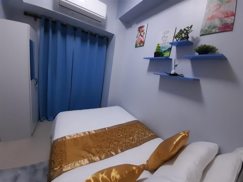 a room with a bed and a couch and a window at FourSphere staycation in Manila