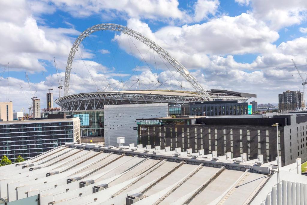 a view of a stadium with a large arch at Modern, Stylish, Canalside PENTHOUSE Apartment Next to Wembley Stadium! in London