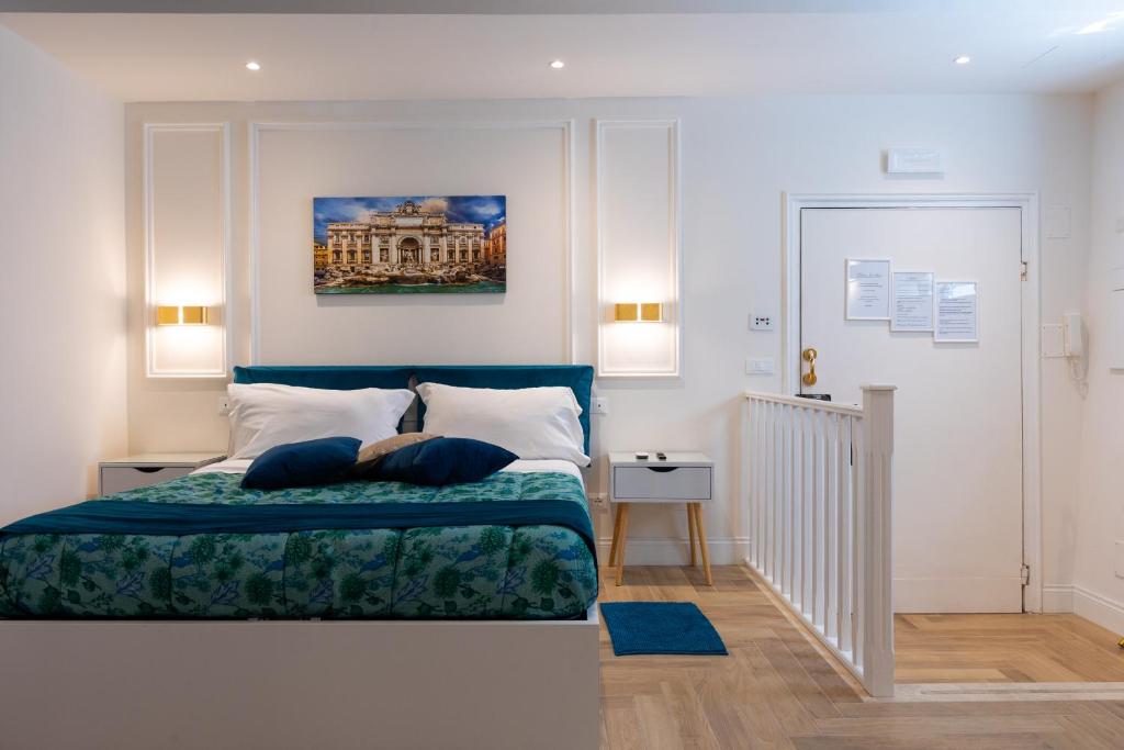 a bedroom with a bed and a painting on the wall at RomeInSuite in Rome