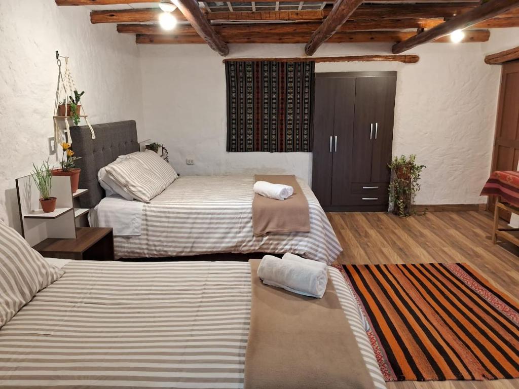 Postel nebo postele na pokoji v ubytování KOSKO Casa Hotel