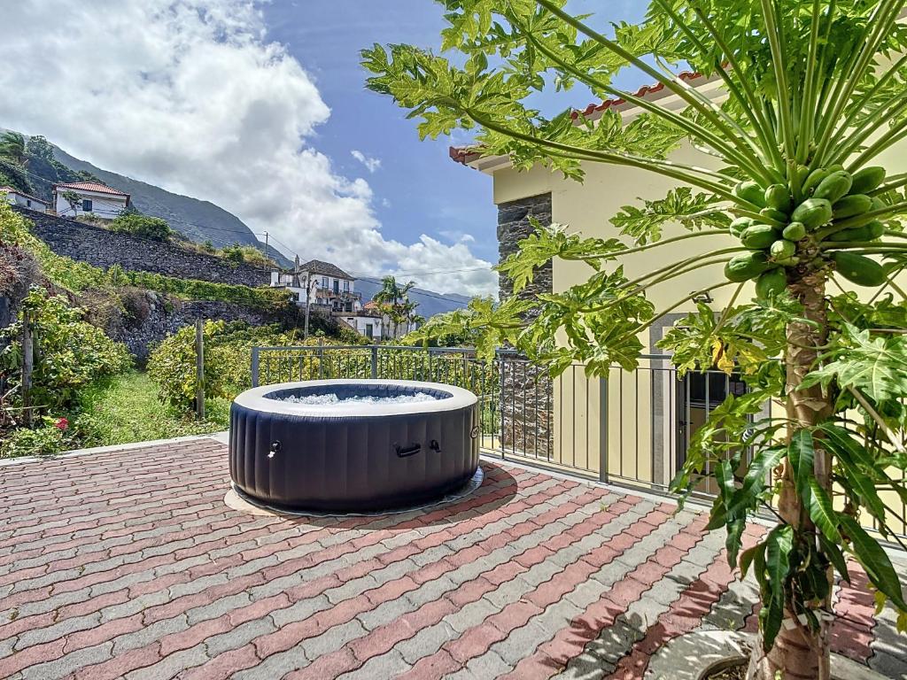 a hot tub sitting on top of a brick patio at My School I by Atlantic Holiday in Ponta Delgada