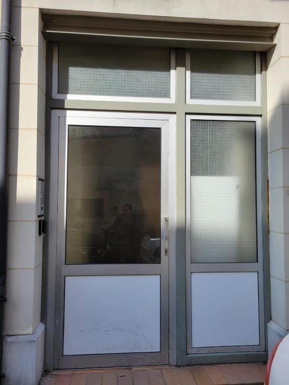 a door with two windows on a building at Bel appartement hyper centre, 3 pièces 60m² in Périgueux
