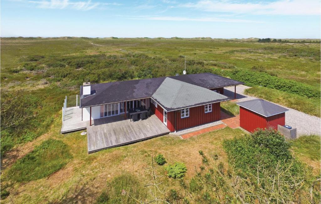 an overhead view of a red house in a field at Nice Home In Hvide Sande With 3 Bedrooms, Sauna And Wifi in Nørre Lyngvig