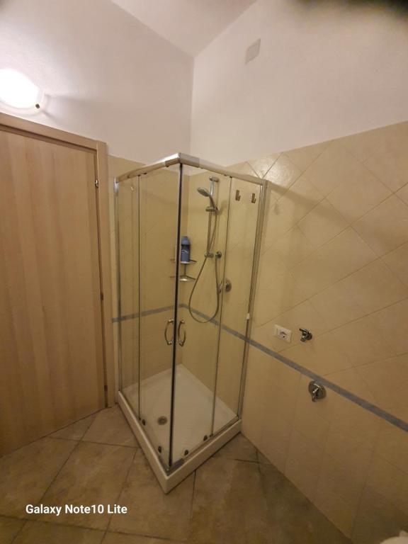 a shower with a glass door in a bathroom at Tranquillo alle porte di como con Box Auto in Malnate