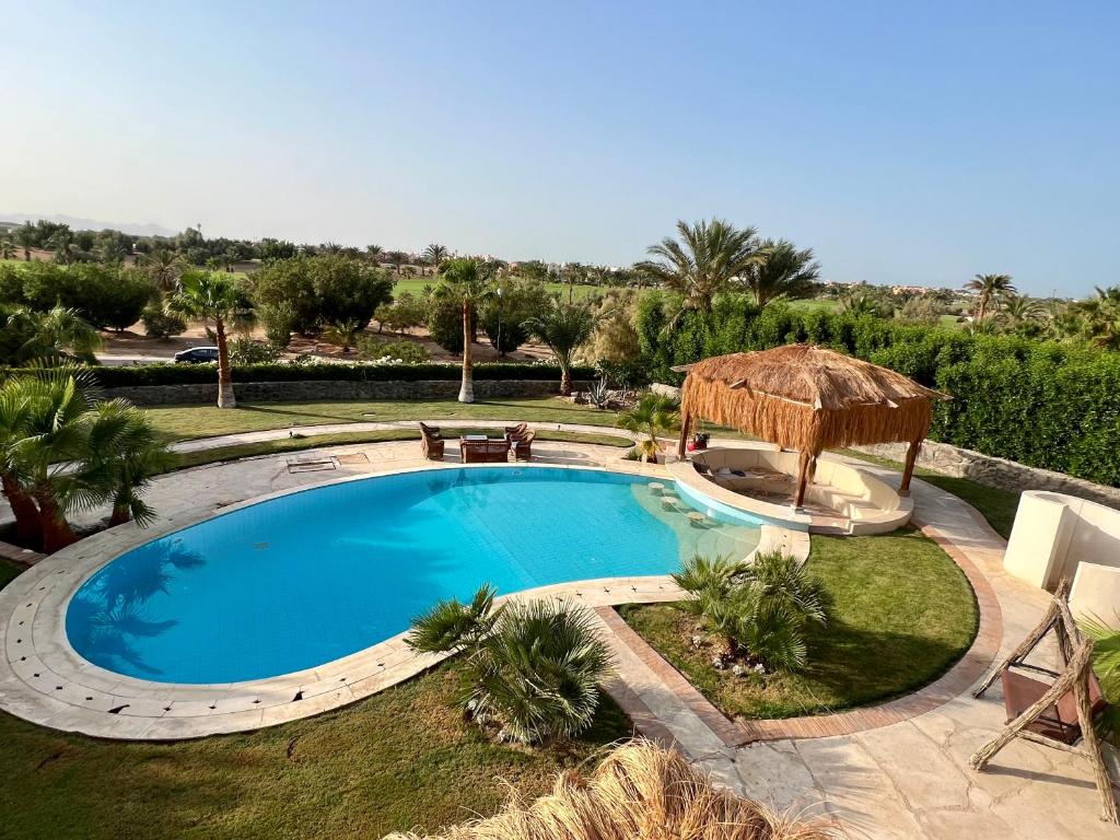 a swimming pool with a gazebo in a yard at GS 23 in Hurghada