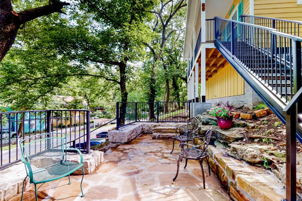 a patio with chairs and tables and stairs at NOLA on Main in Eureka Springs