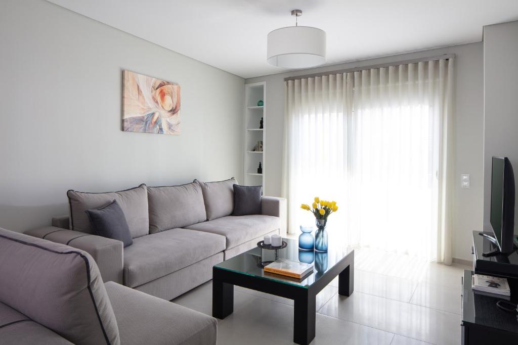 a living room with a couch and a coffee table at Piccadilly House in Arta