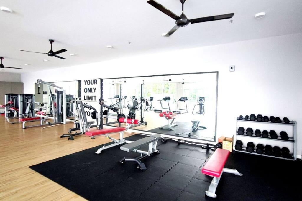 a gym with several treadmills and exercise machines at Luxury Suite Alanis Residence Sepang KLIA1 KLIA2 Putrajaya Cyberjaya in Sepang
