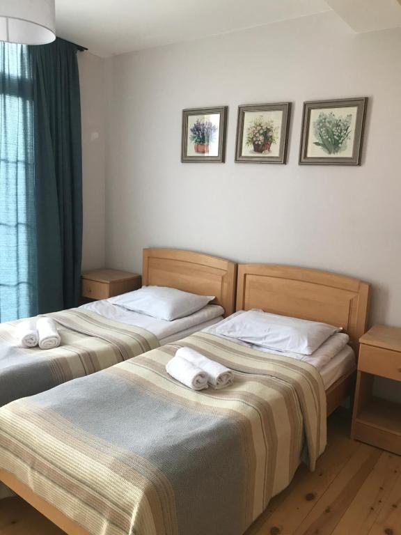 two beds sitting next to each other in a room at Boutique hotel mestia in Mestia