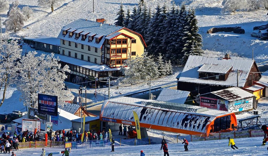 a group of people in the snow near a train station at Absolwent in Zieleniec