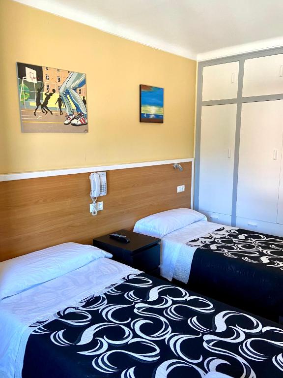 Postel nebo postele na pokoji v ubytování Hotel Les Roques